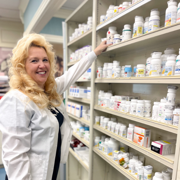 pharmacist grabbing mediction from shelf