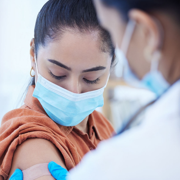 pharmacist giving immunization shot to patient